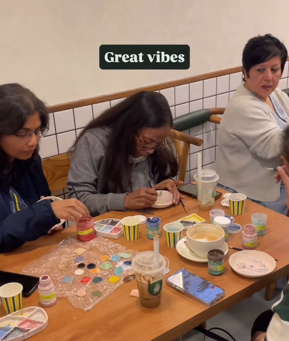 Guests painting handcrafted ceramic pieces at the Sip and Paint workshop